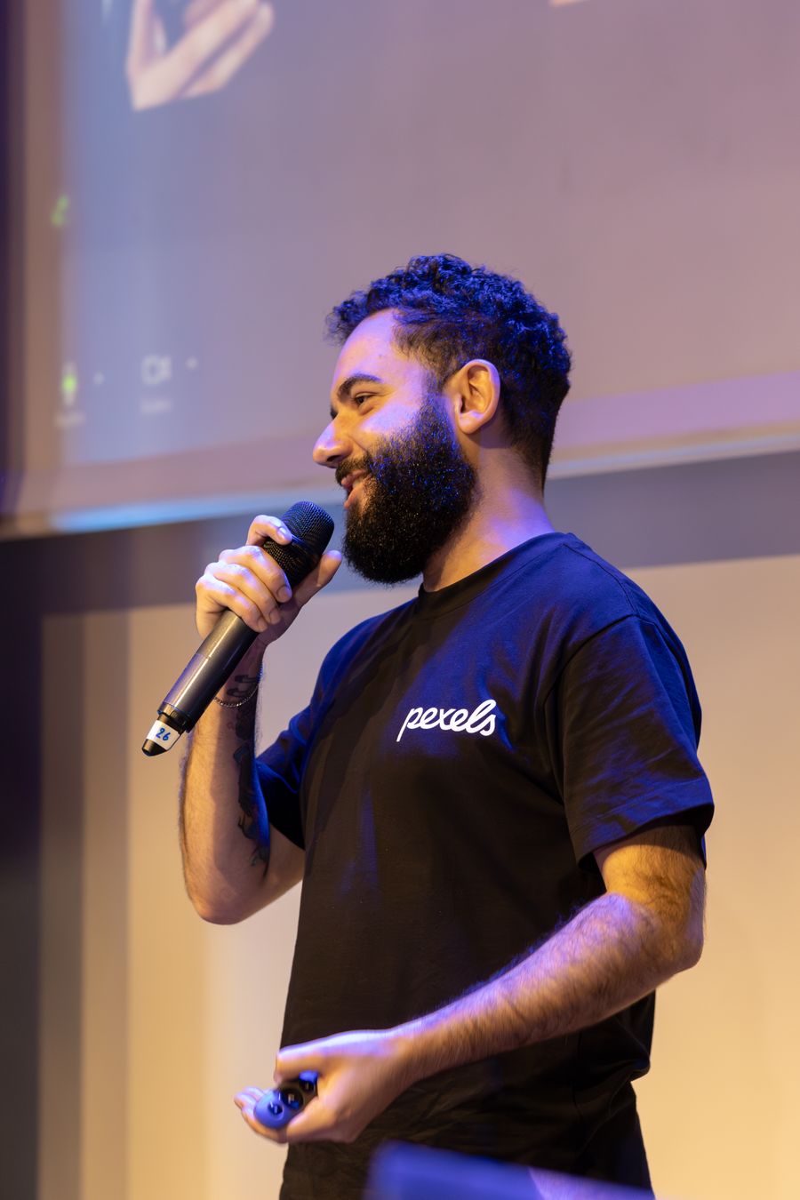 A speaker talking casually at an indoor event