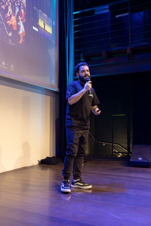 Free A speaker giving a presentation on stage during a conference. Stock Photo