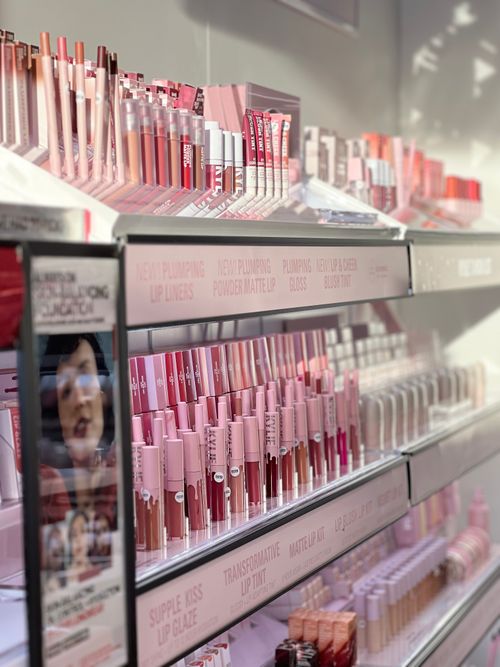 Free Vivid display of various lip products on shelves. Perfect for beauty and retail concepts. Stock Photo