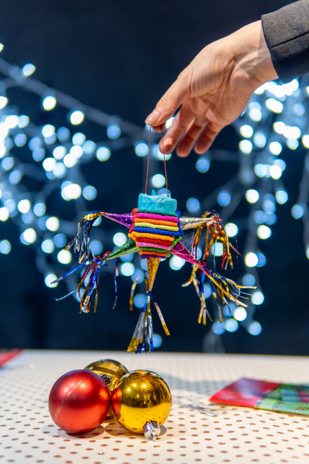 Hand Pinata Festive Hand Holding Colorful Christmas Piñata · Free Stock Photo