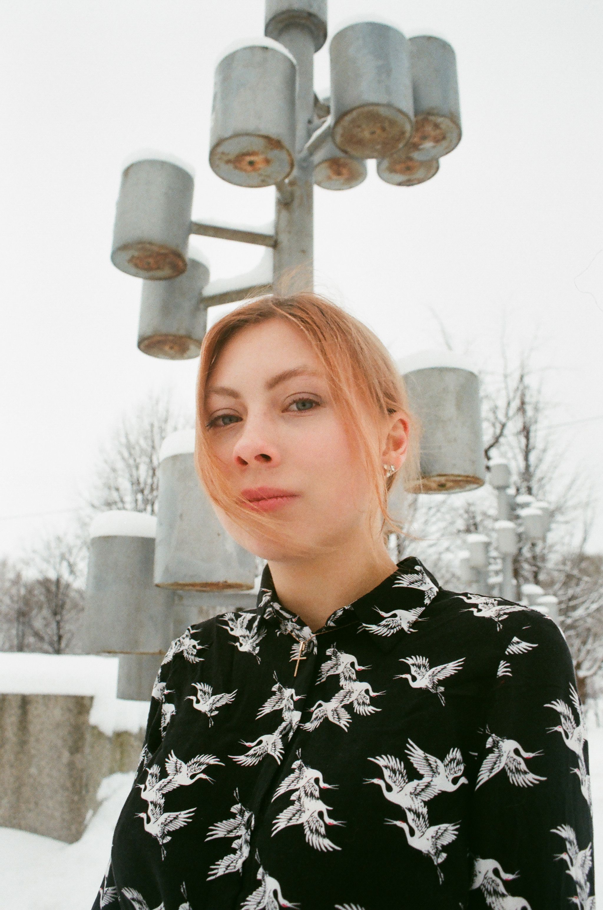 Portrait of a young woman outdoors on a winter day, showcasing fashion and style.