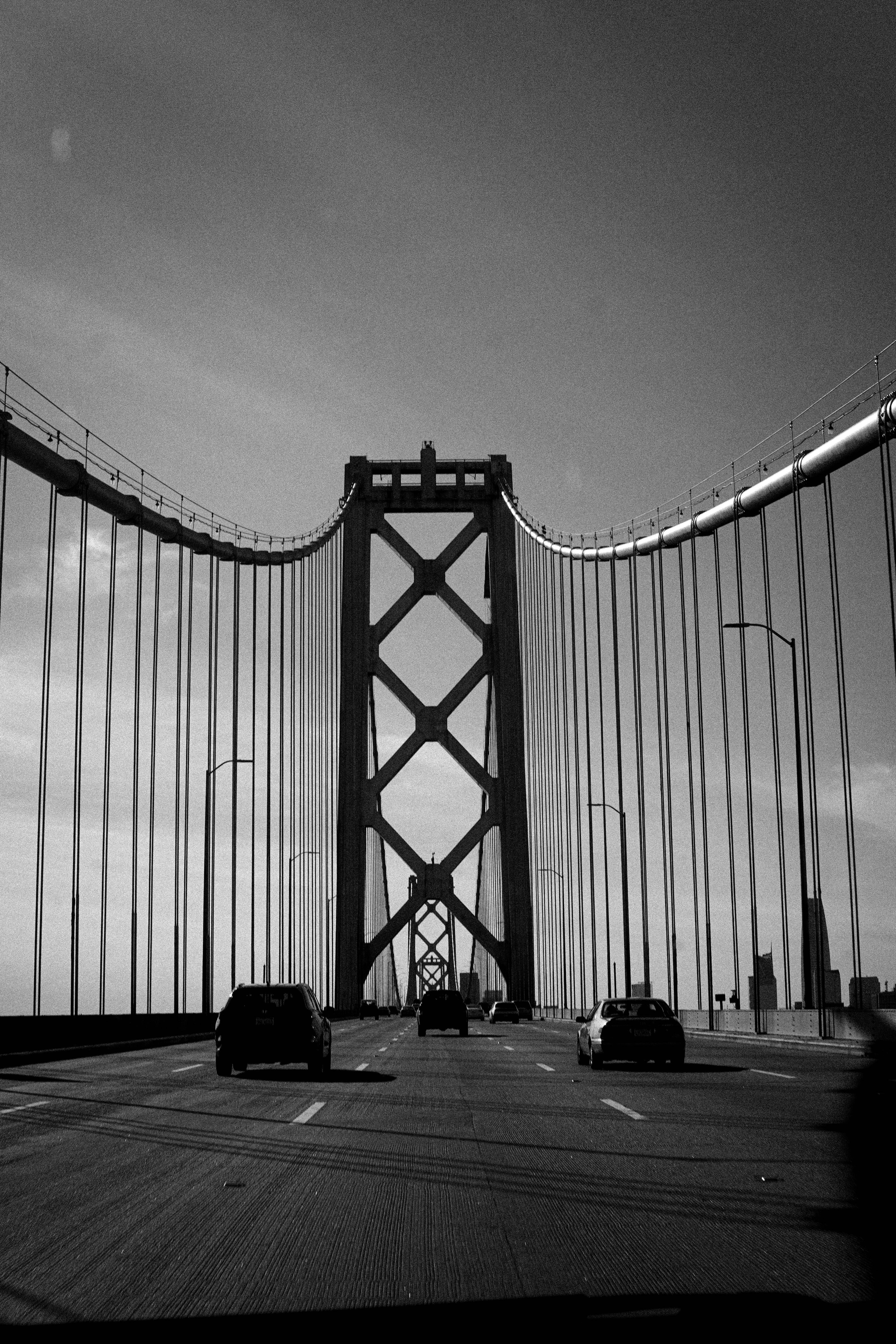 Black and white view of cars crossing the iconic Bay Bridge in San Francisco.