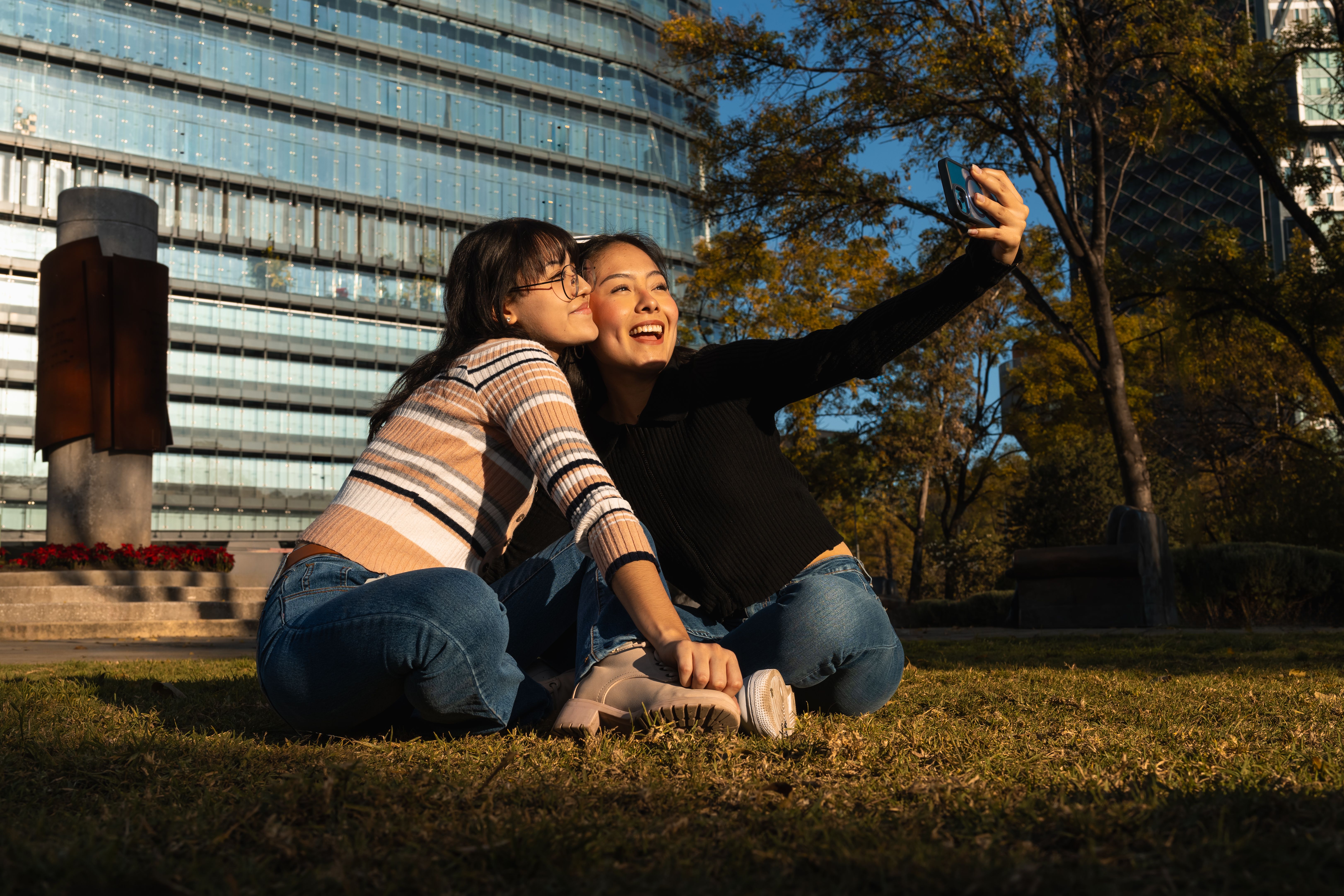 Young Women Taking a Selfie Outdoors in Urban Park · Free Stock Photo
