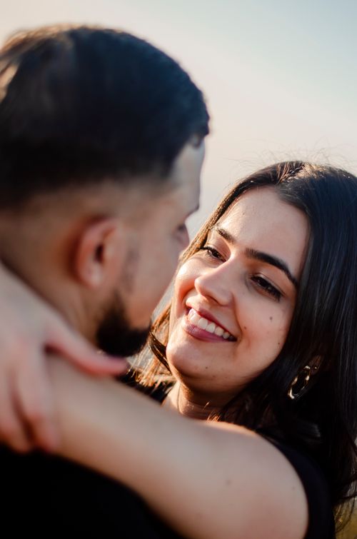 Free A young couple lovingly embraces outdoors, showcasing affection and joy. Stock Photo