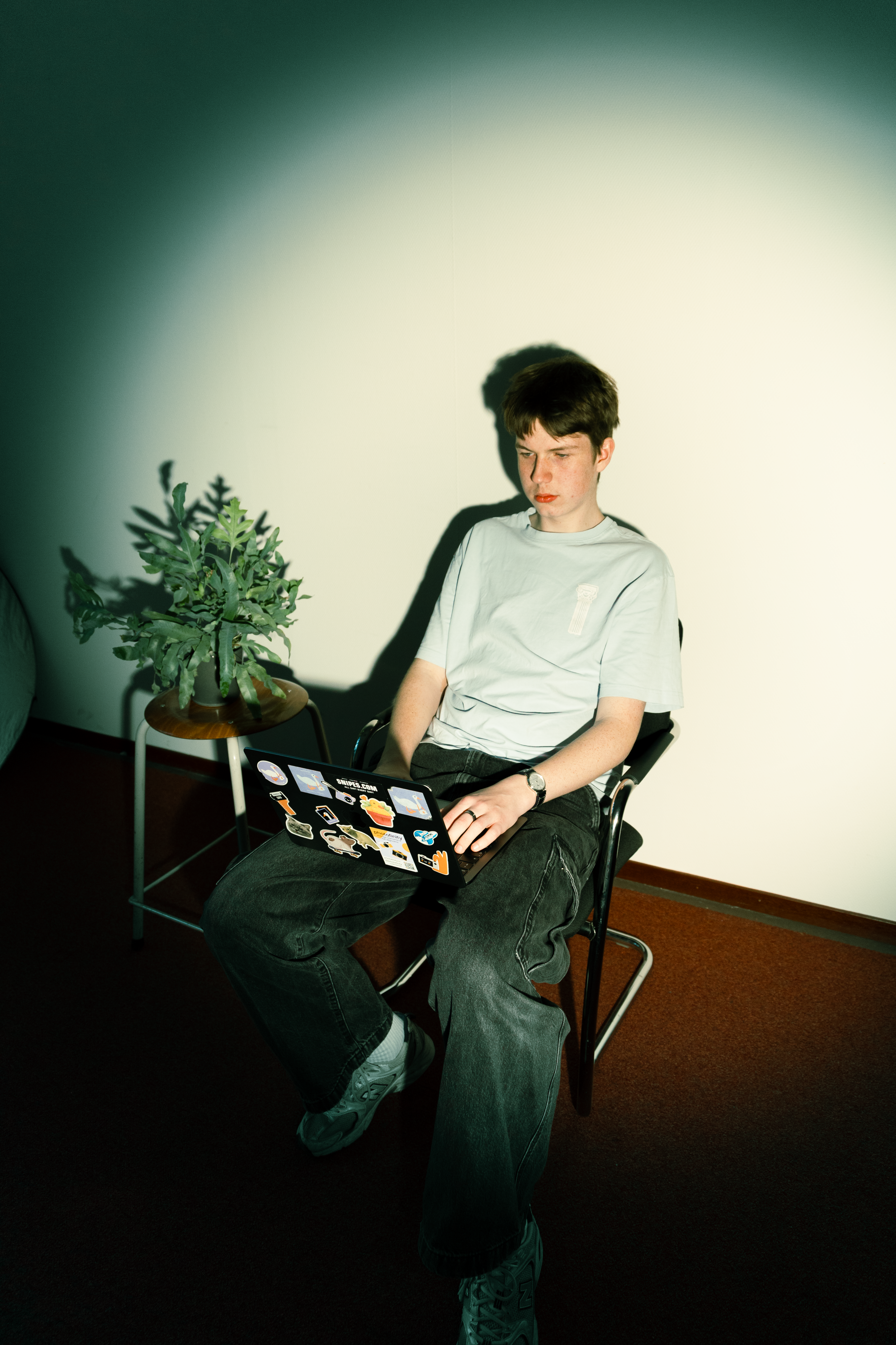 A person sitting in a minimalist room, looking calm and focused
