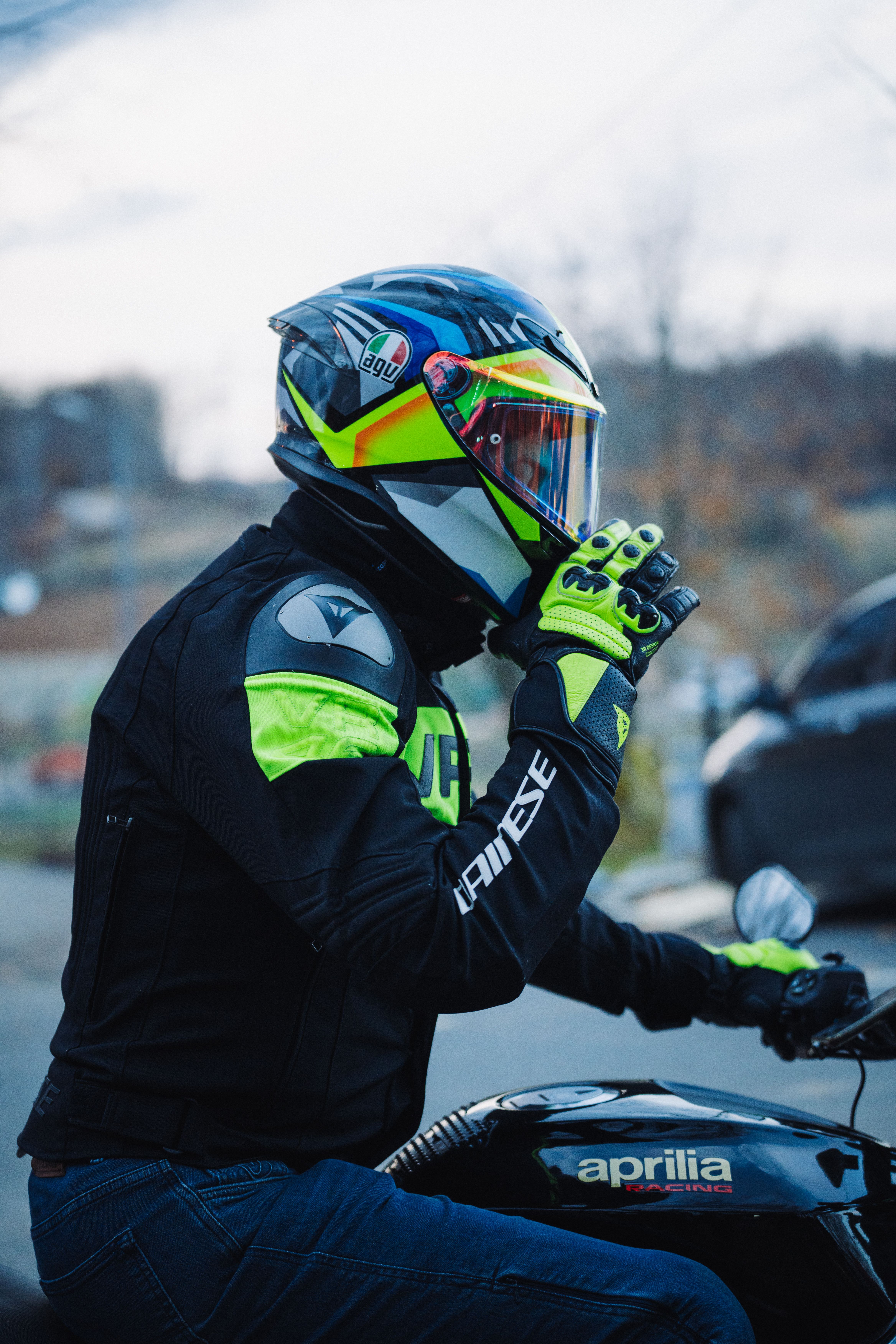Rider on motorcycle wearing high-visibility gear and helmet, capturing urban biker lifestyle.