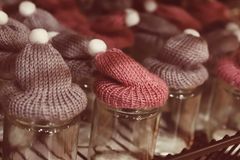 Hand-knitted beanies on a shelf — photo by Christina & Peter on Pexels