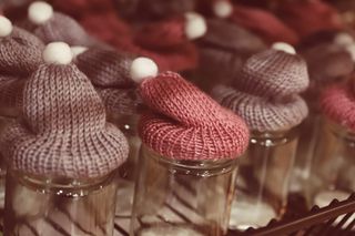 Hand-knitted beanies on a shelf — photo by Christina & Peter on Pexels