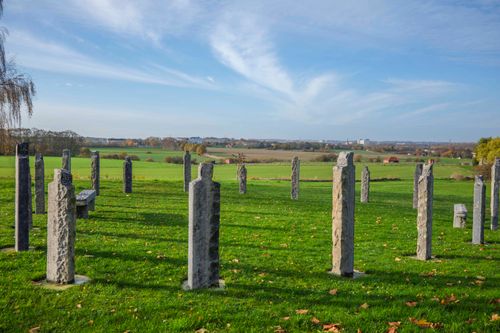 Free Stone monuments in a sunny Bierbeek field with scenic countryside views. Stock Photo