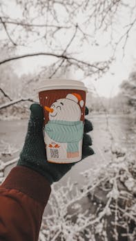 Warm beverage enjoyed by a frozen lake, capturing the essence of a cozy winter morning.