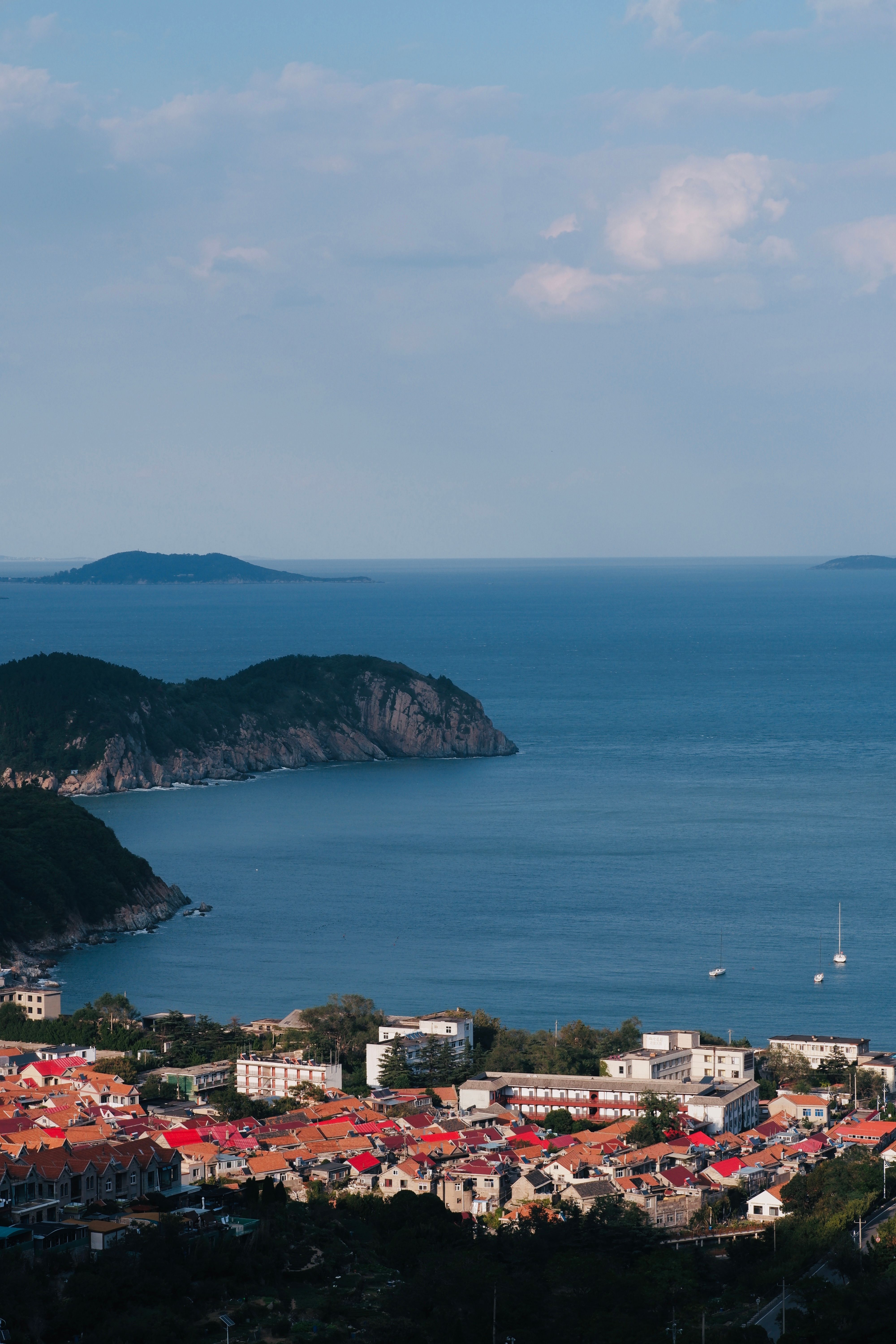 Scenic Coastal Town Overlooking Calm Bay · Free Stock Photo