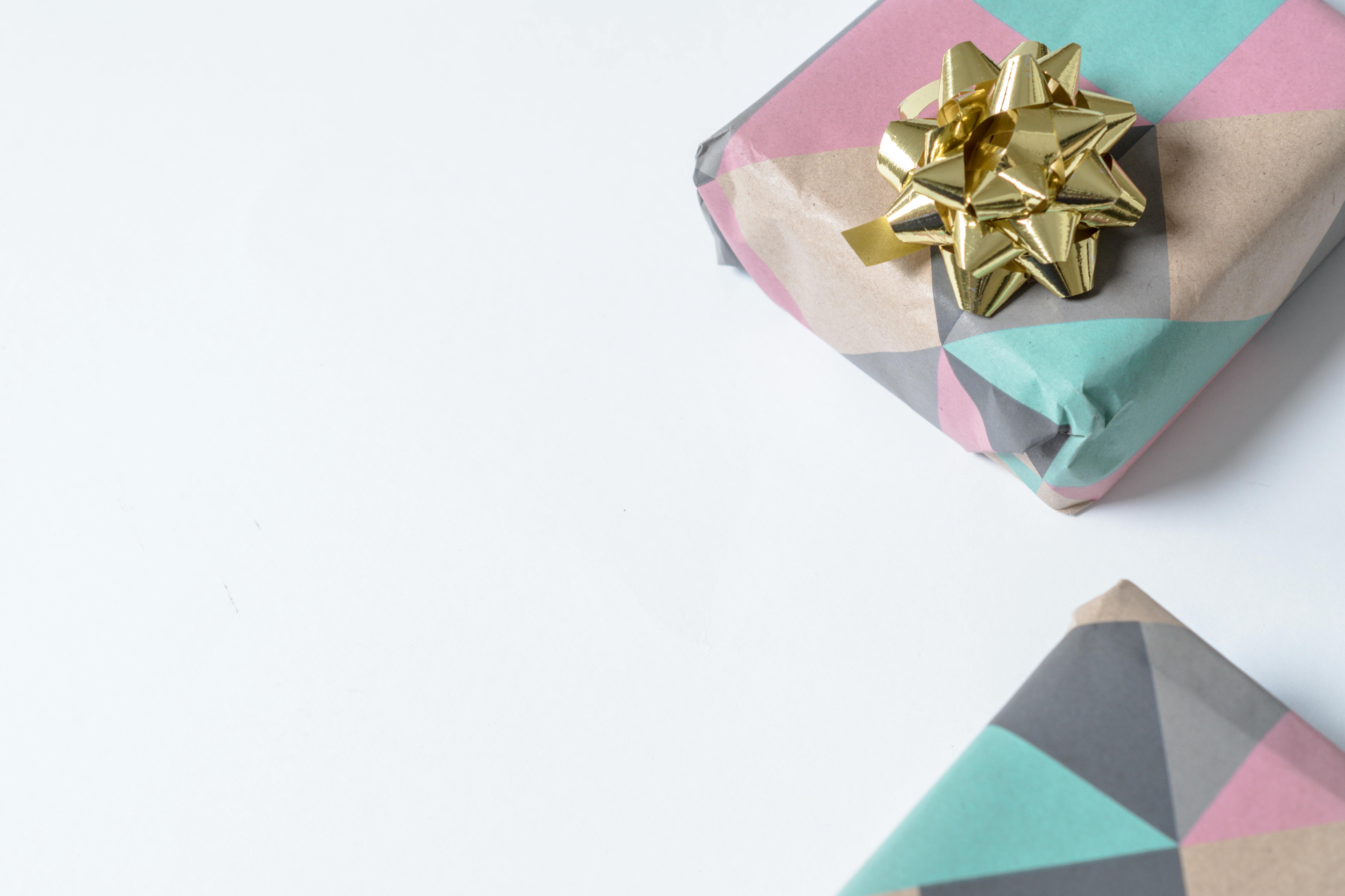 colorful gifts with golden bow on white background