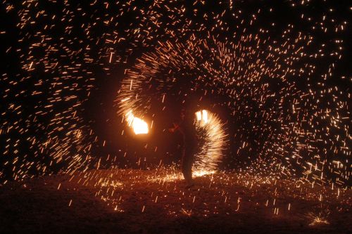 Free A mesmerizing fire dancer creates dazzling light patterns in Agafay Desert, Morocco. Stock Photo