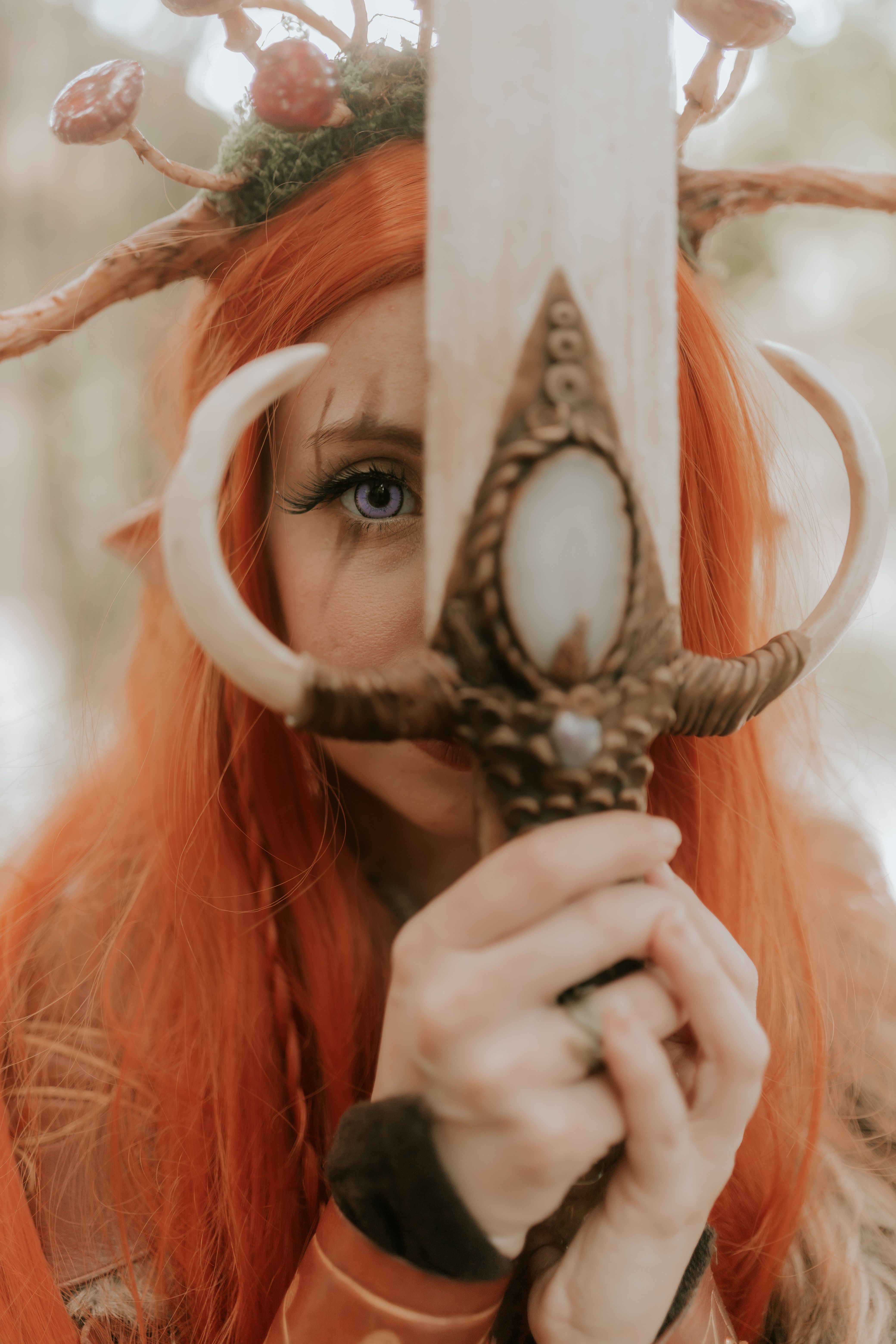 Captivating image of a female elf warrior holding a mystical sword in a forest setting.
