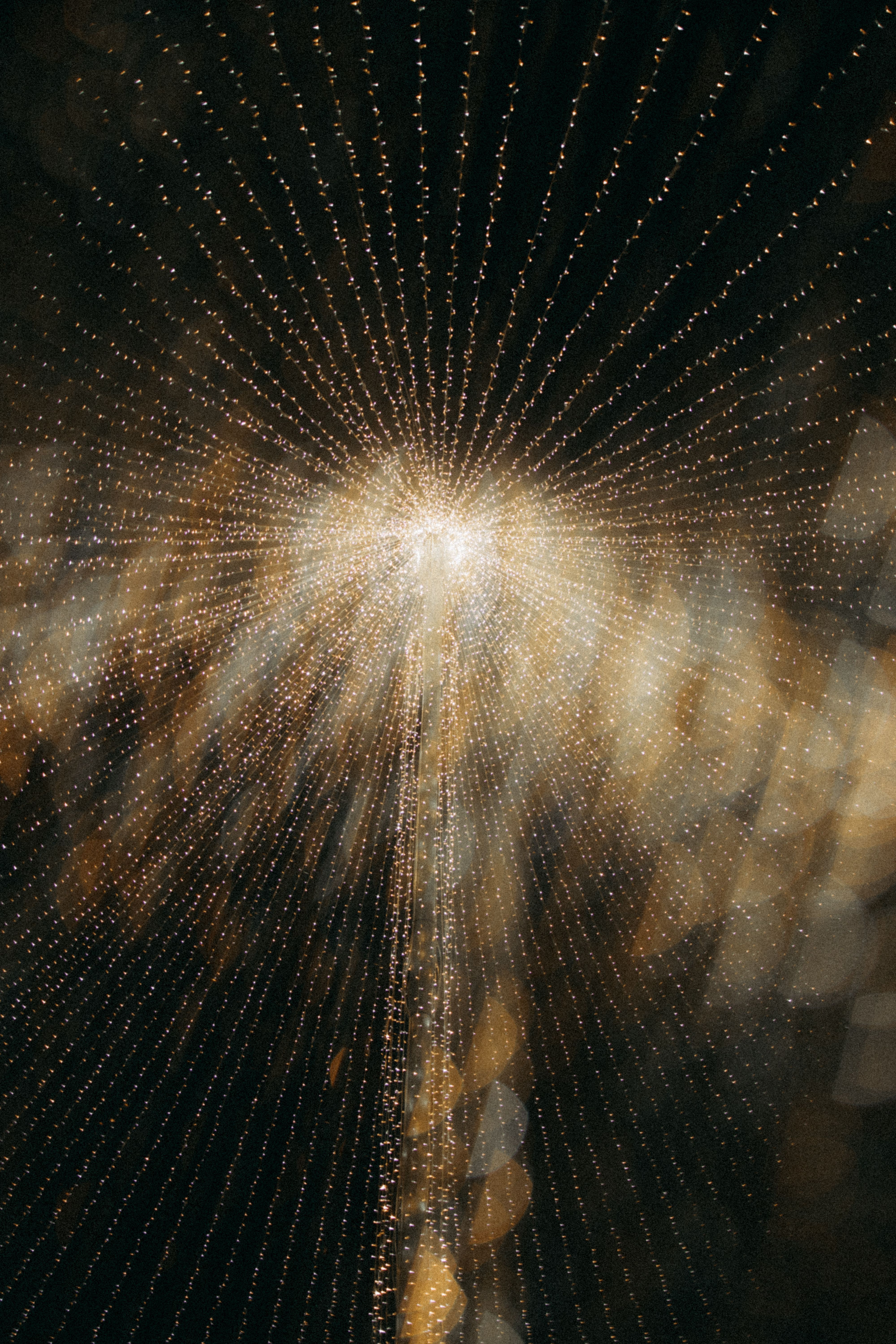 Dazzling abstract image of a radiant golden light burst with bokeh effect.
