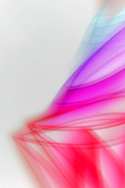 Free A vibrant abstract image featuring flowing colorful light waves in red, pink, and purple on a white background. Stock Photo