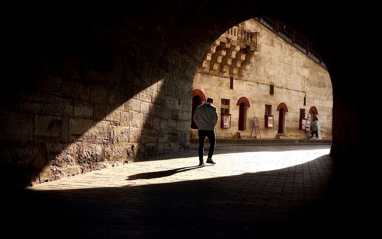 A shaft of light across a vaulted stone hall — photo by Huseyin Ergul on Pexels