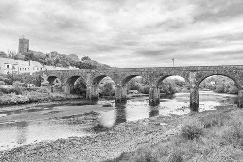Free Black and white photo of a historic stone bridge over a river in Newport, County Mayo. Stock Photo