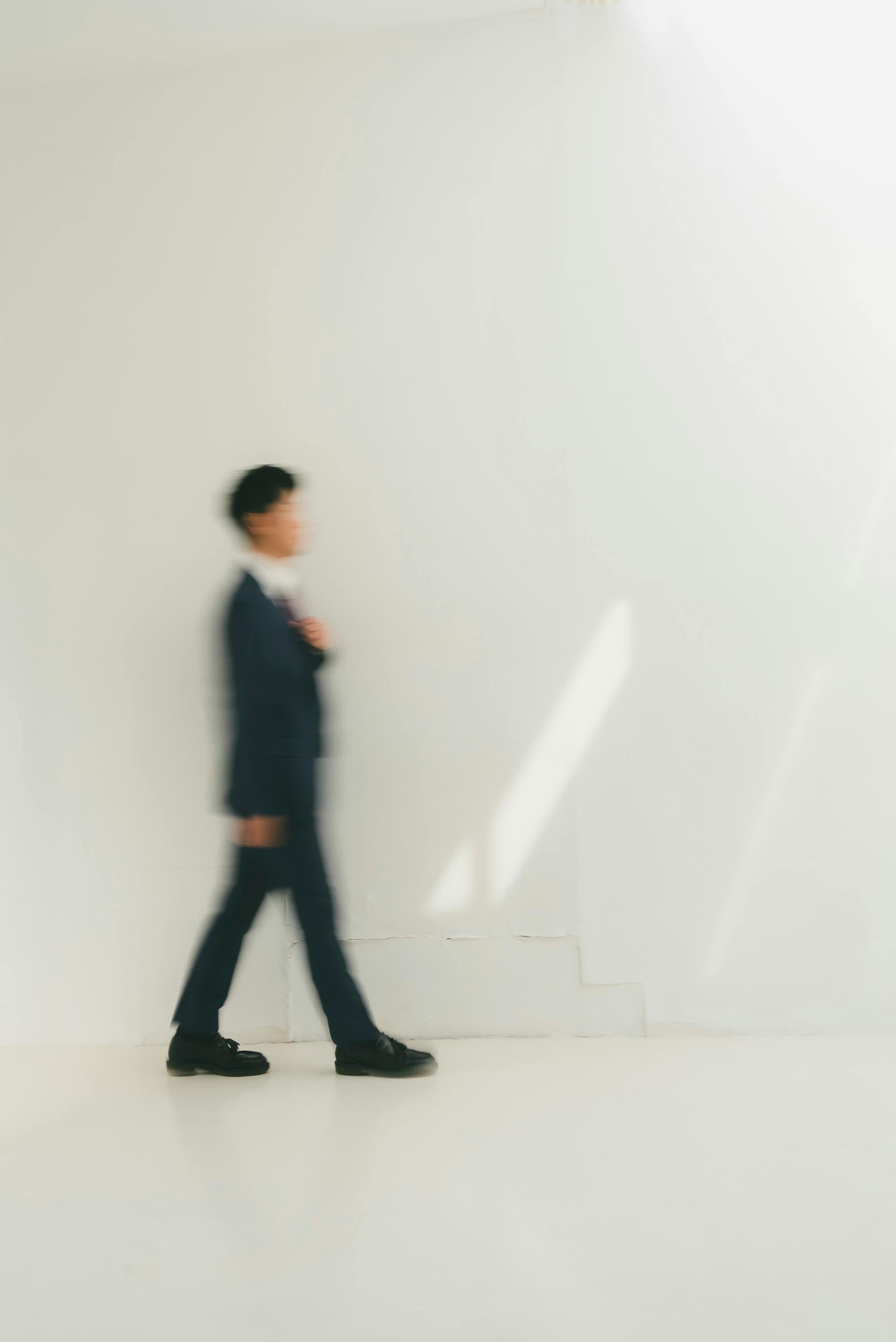 Artistic photo of a man in motion, showcasing a minimalist style with soft tones.