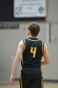 Back view of basketball player wearing jersey number 4 during a game.
