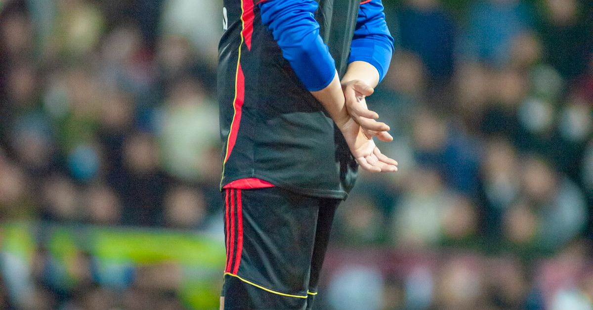 Soccer Coach Observing Match on Field · Free Stock Photo