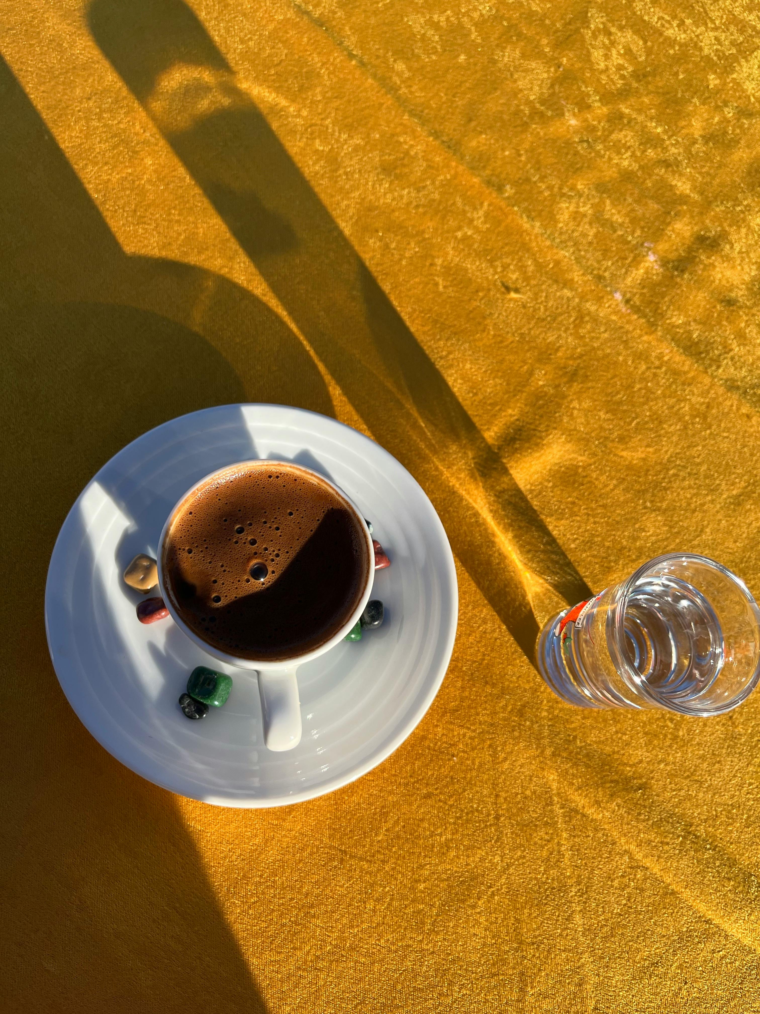 top view of coffee cup and glass on orange table