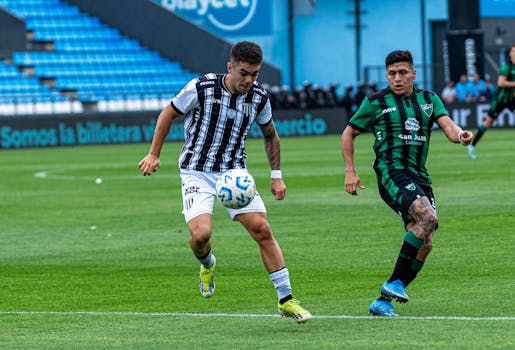 Two soccer players in action during a competitive sports match on the field.