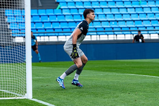 Goalkeeper in action during a soccer game, ready to defend the goal.