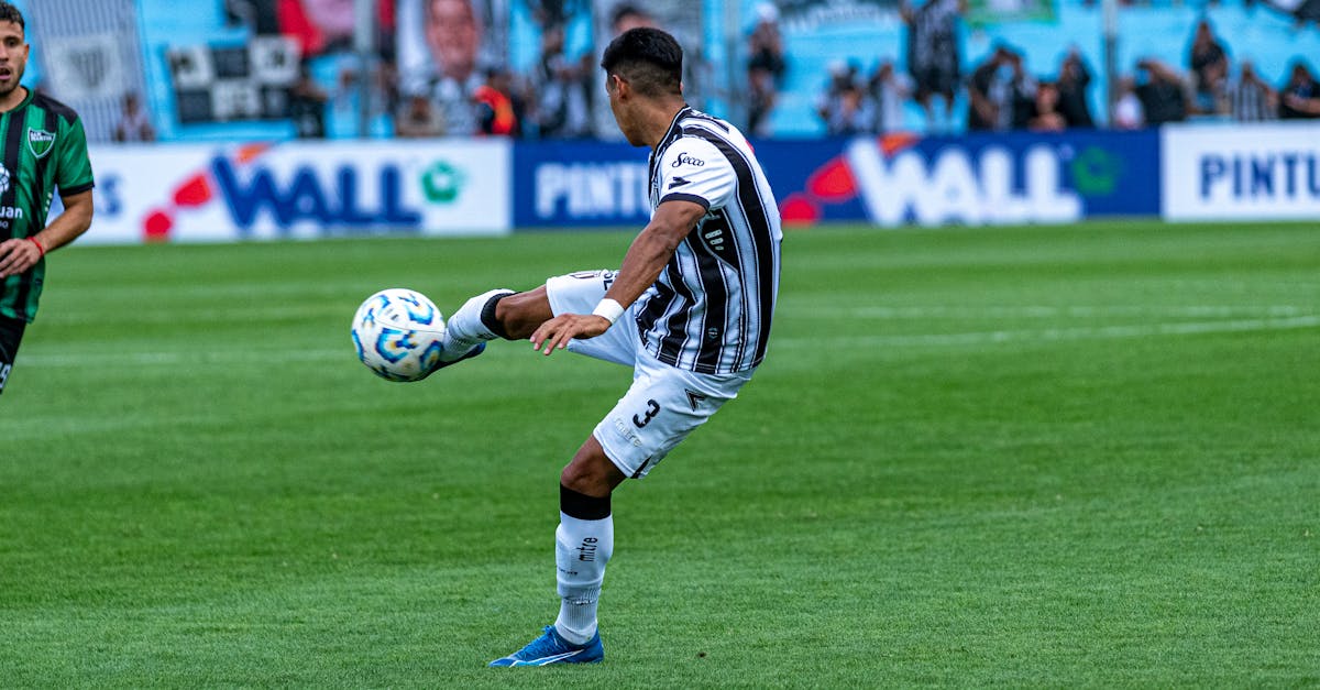 Dynamic shot of a soccer match with players in action on a grassy field.