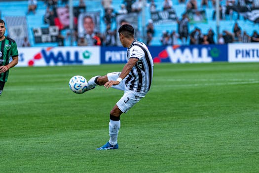 Dynamic shot of a soccer match with players in action on a grassy field.