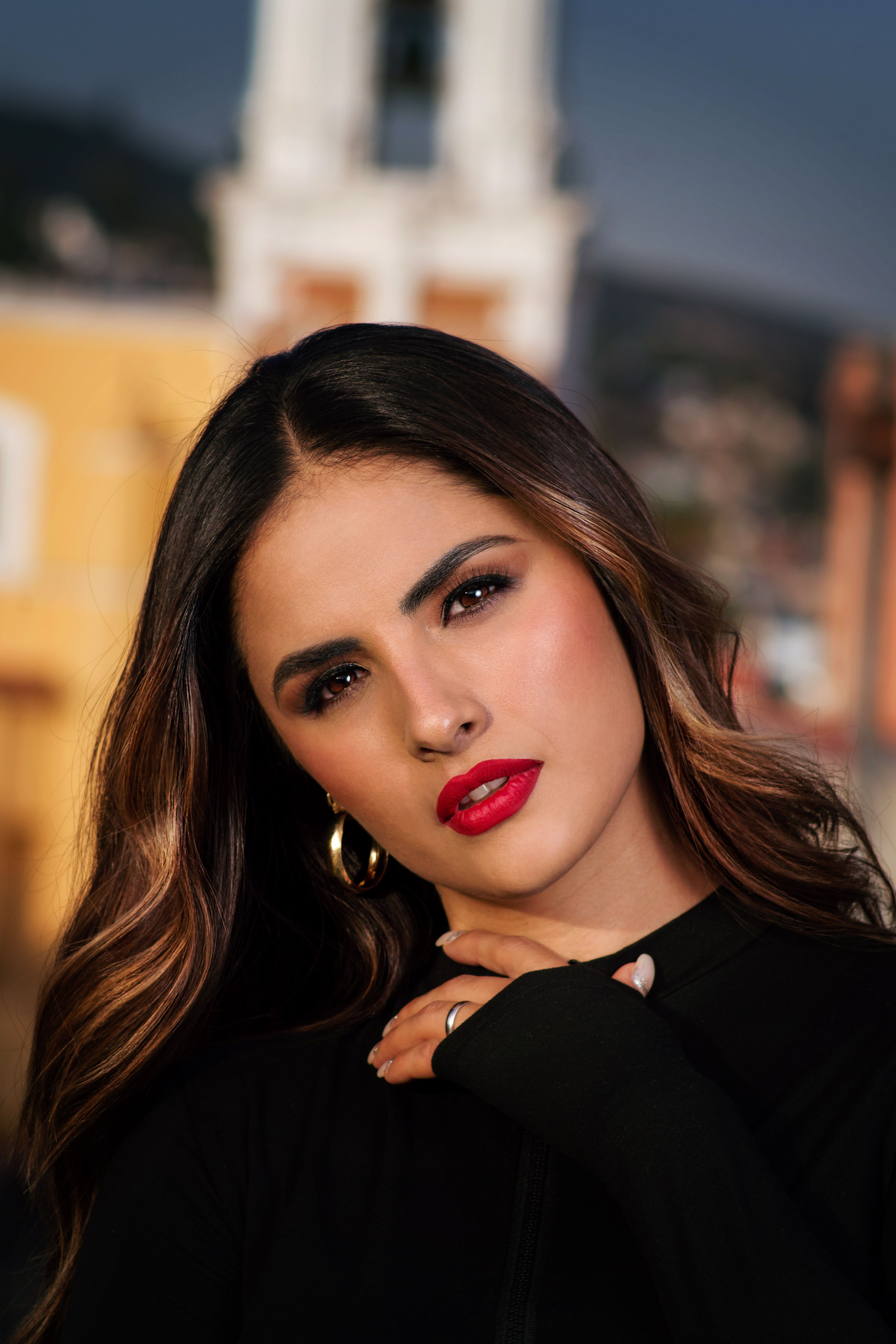 Stunning portrait of a woman in Tlaxcala, Mexico with a historic backdrop.