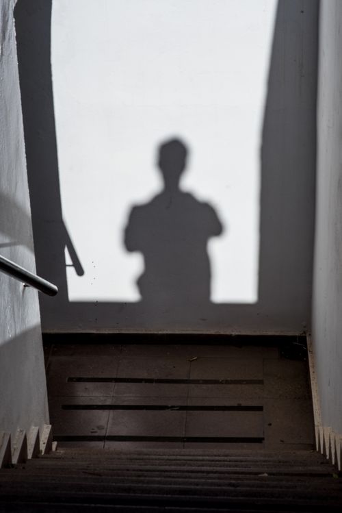 Free Shadow silhouette on a stairway walls creates a mysterious and eerie mood. Stock Photo