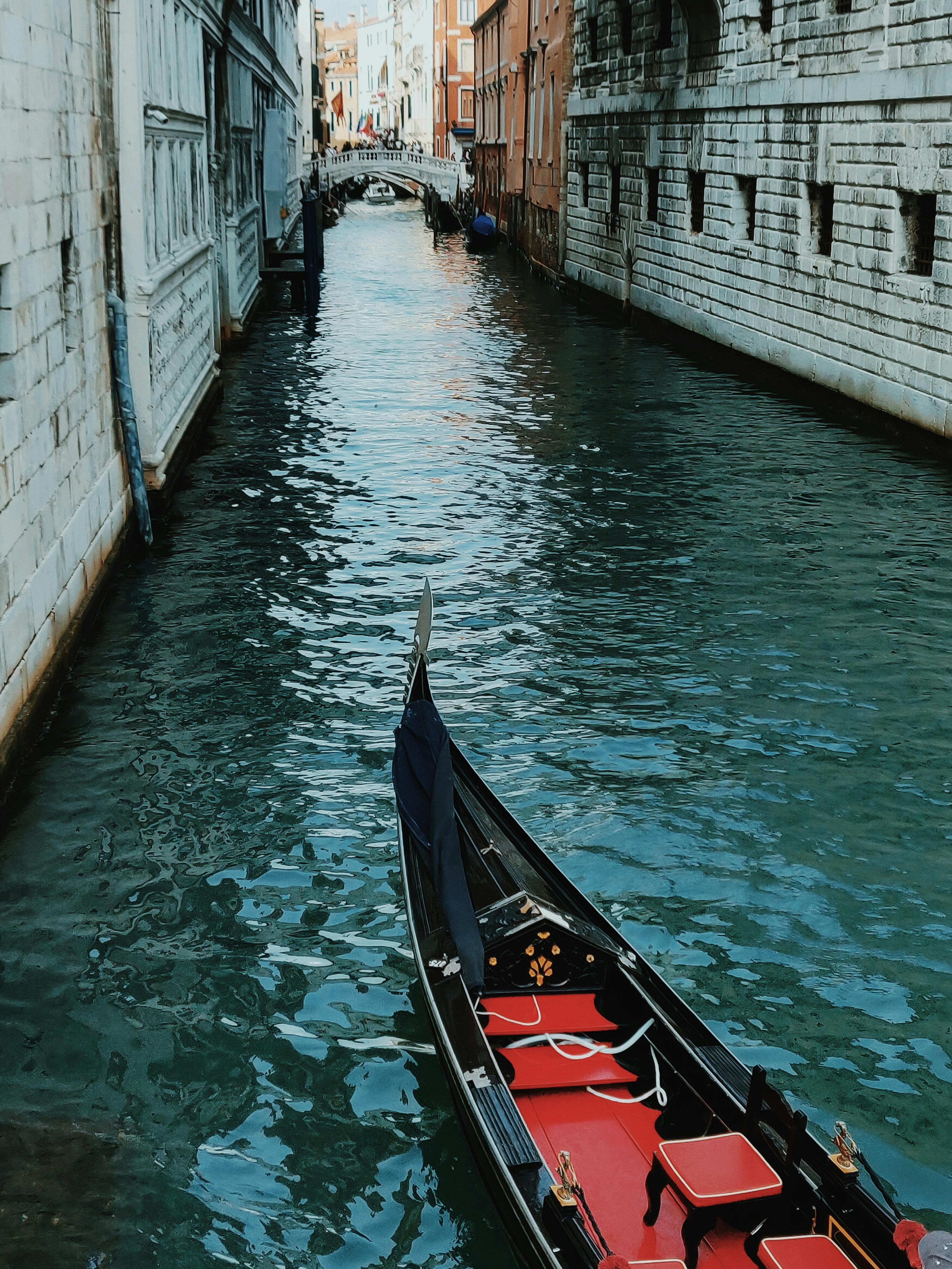 black and red touring boat on grand canal