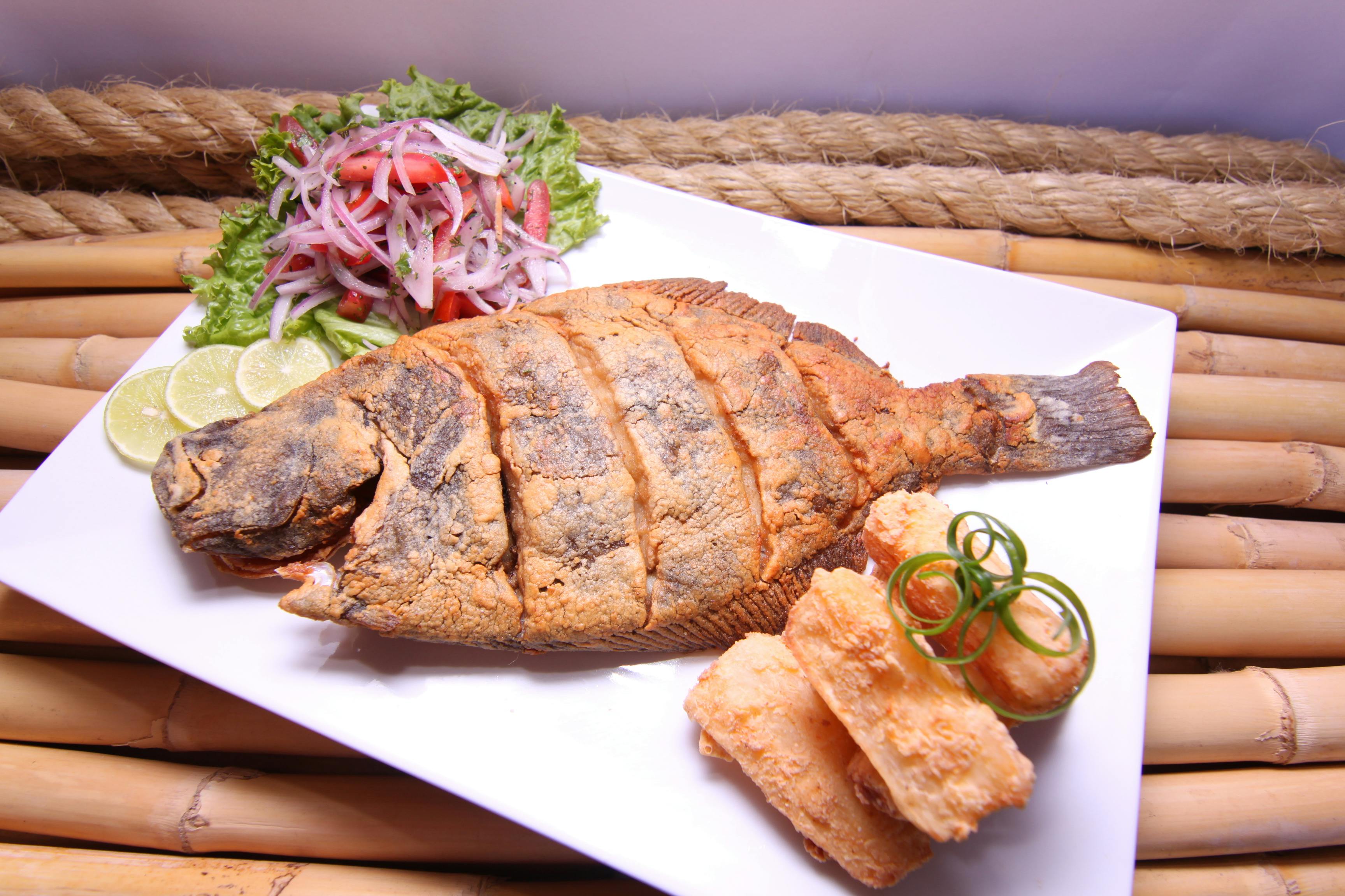 crispy fried fish with fresh salad and lime