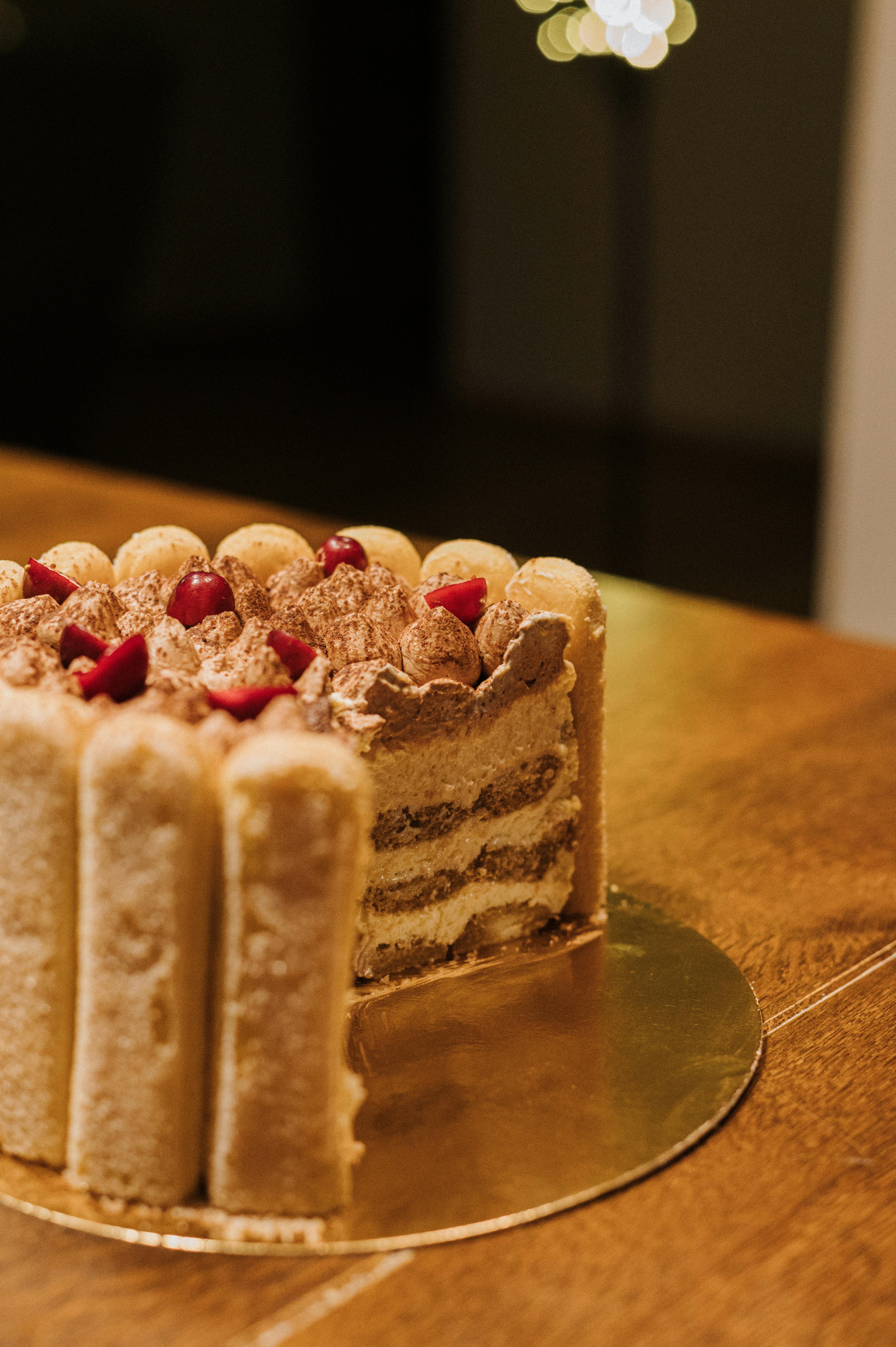 delicious layered tiramisu cake on wooden table