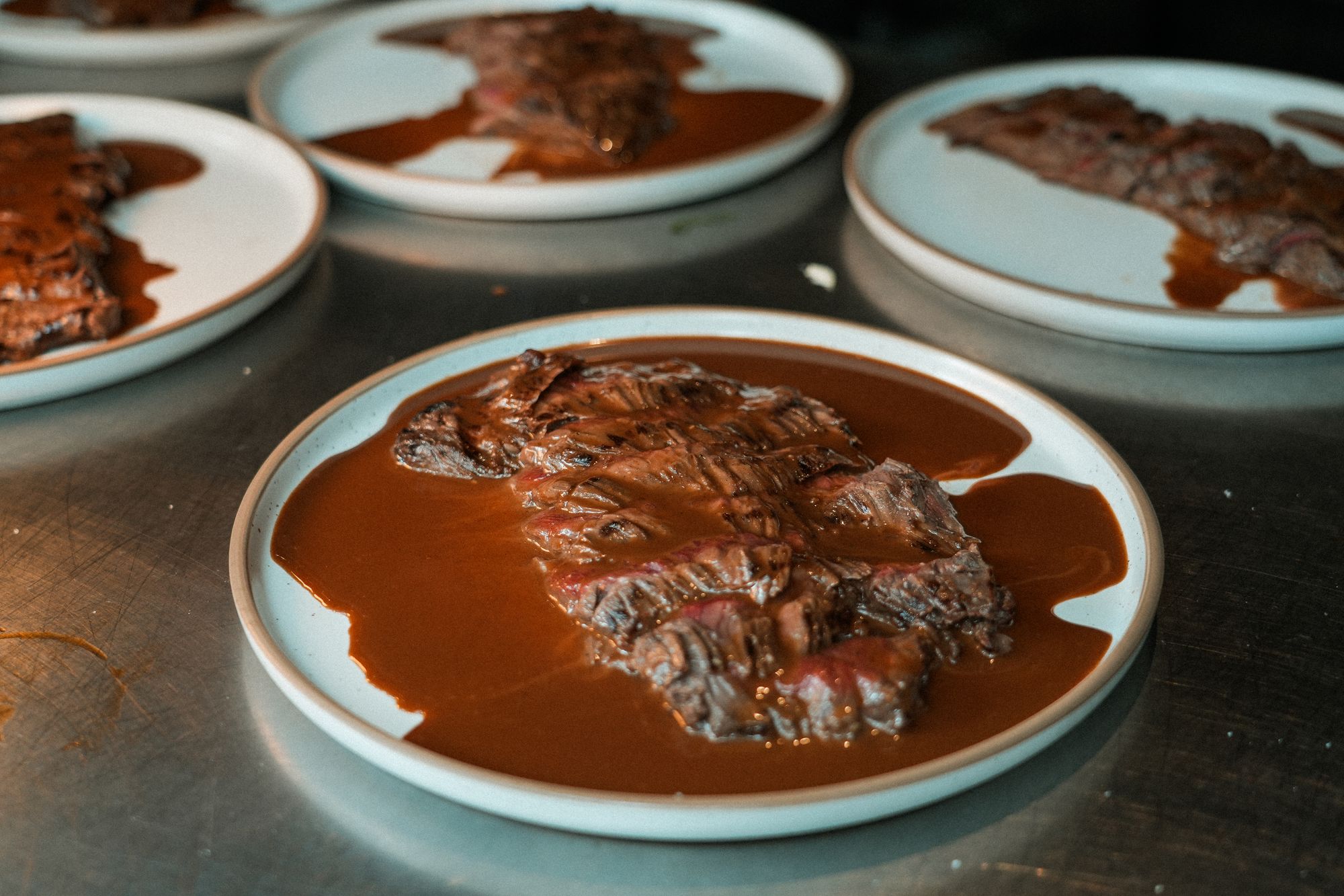 Sliced picanha served generously with rich barbecue sauce