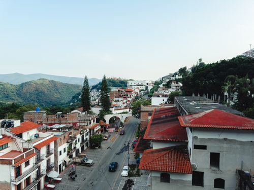 Free Aerial view of charming Taxco, Guerrero with red roofs and lush hills. Stock Photo