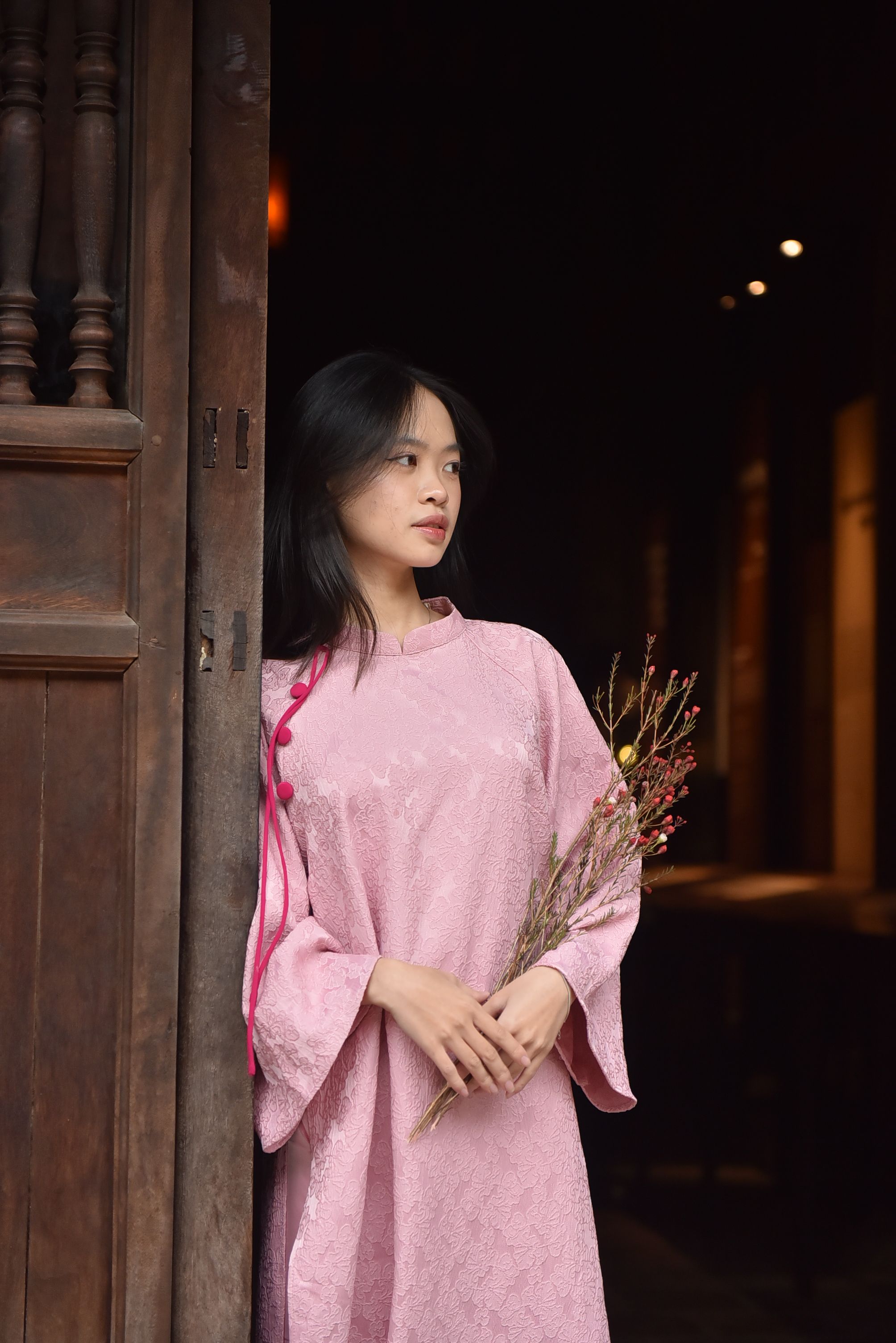 Woman in Pink Dress Holding Flowers Indoors · Free Stock Photo