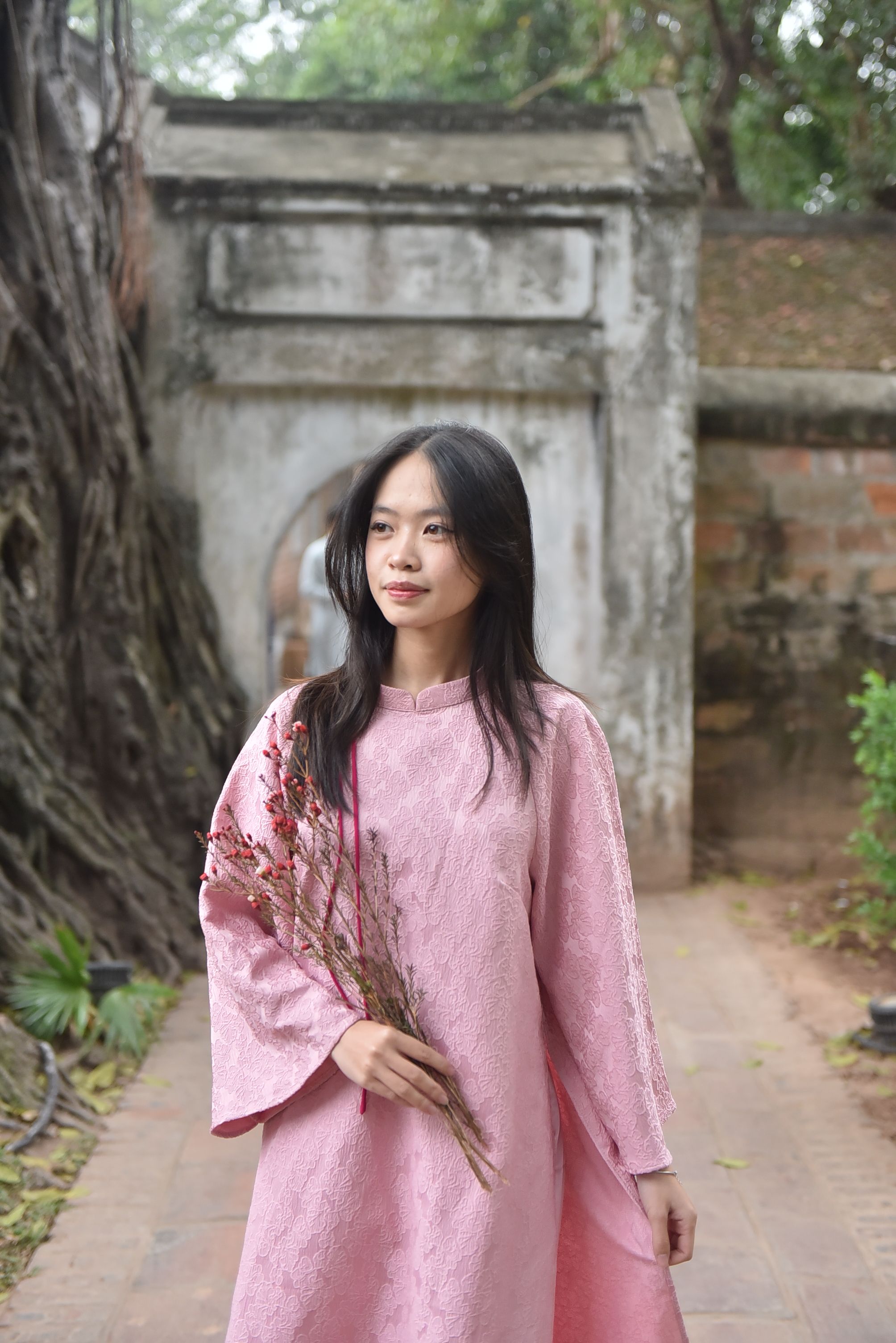 Woman in Traditional Pink Dress Holding Flowers · Free Stock Photo