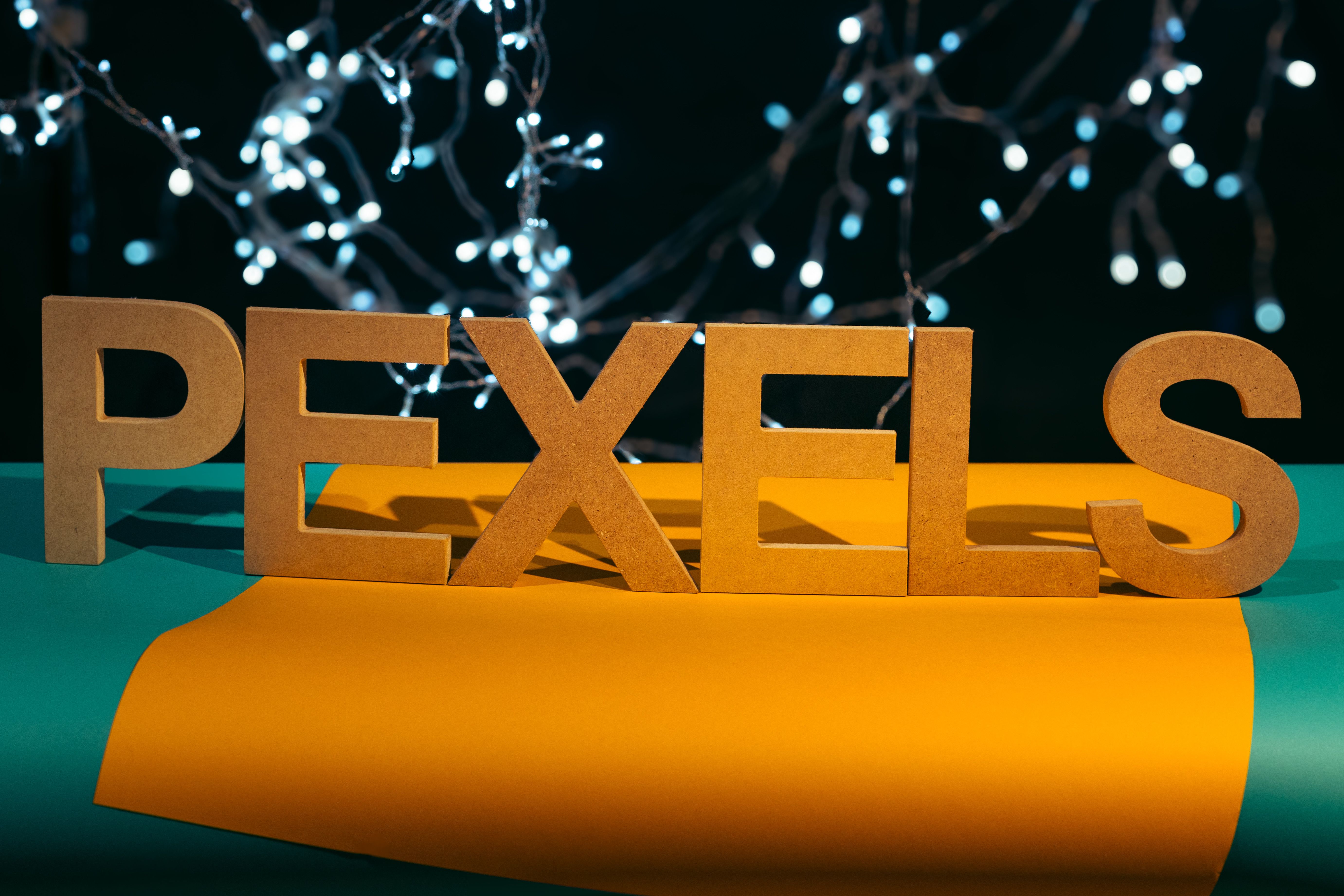 Wooden Letters with Twinkling Lights Background · Free Stock Photo