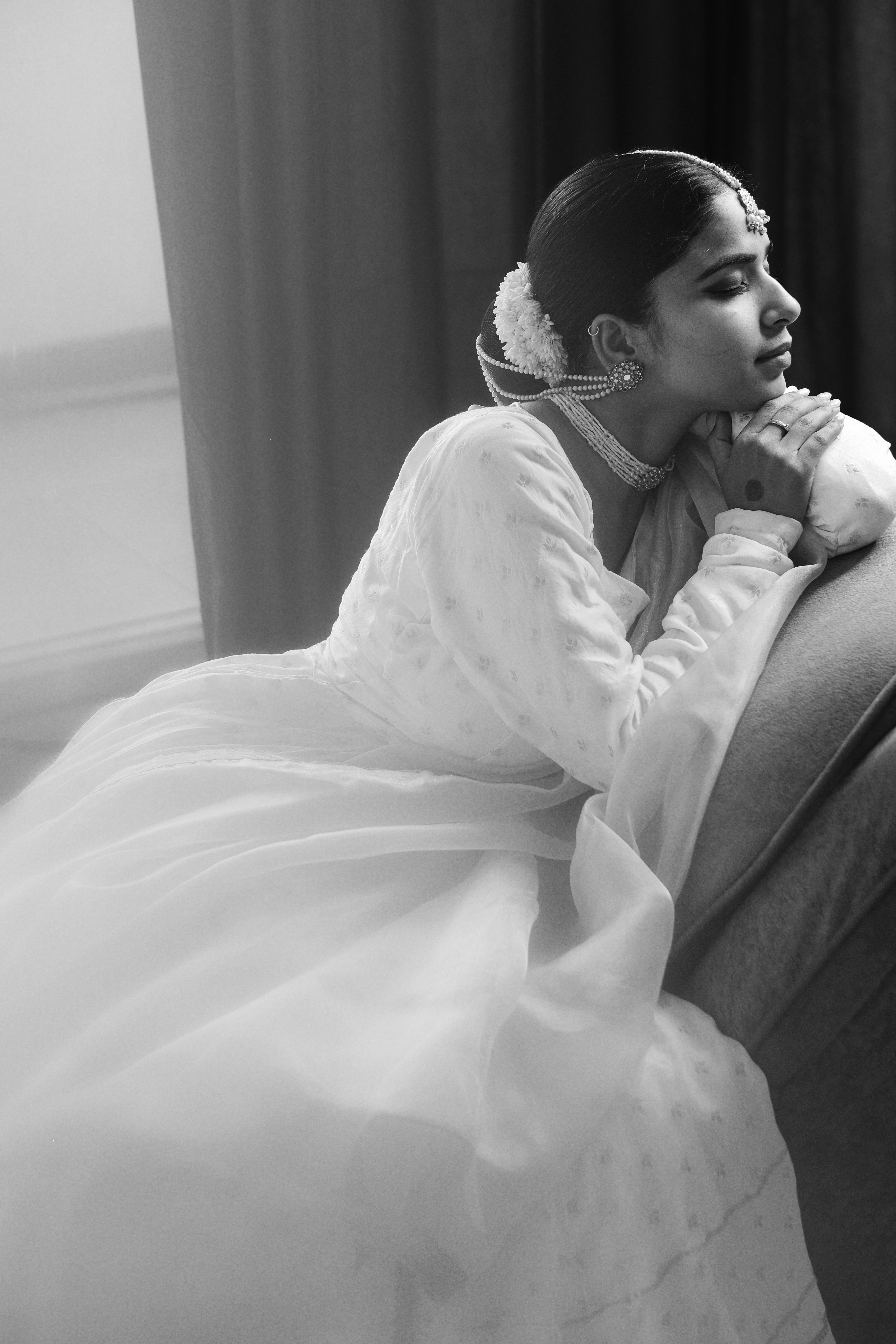 Black and white portrait of a woman in traditional Indian attire, exuding elegance and grace.