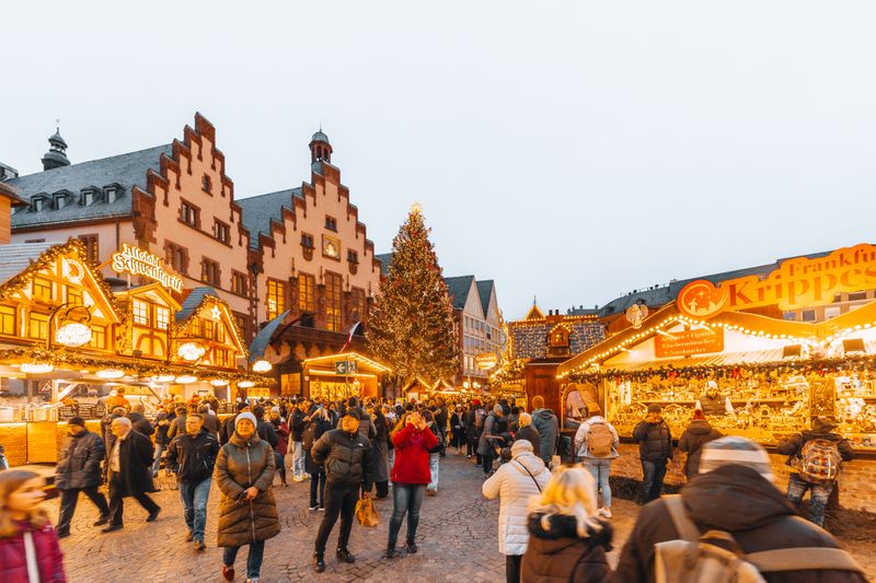 Târg de Crăciun european cu luminițe festive și brad mare