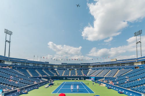 People Standing on Blue and Green Tennis Court