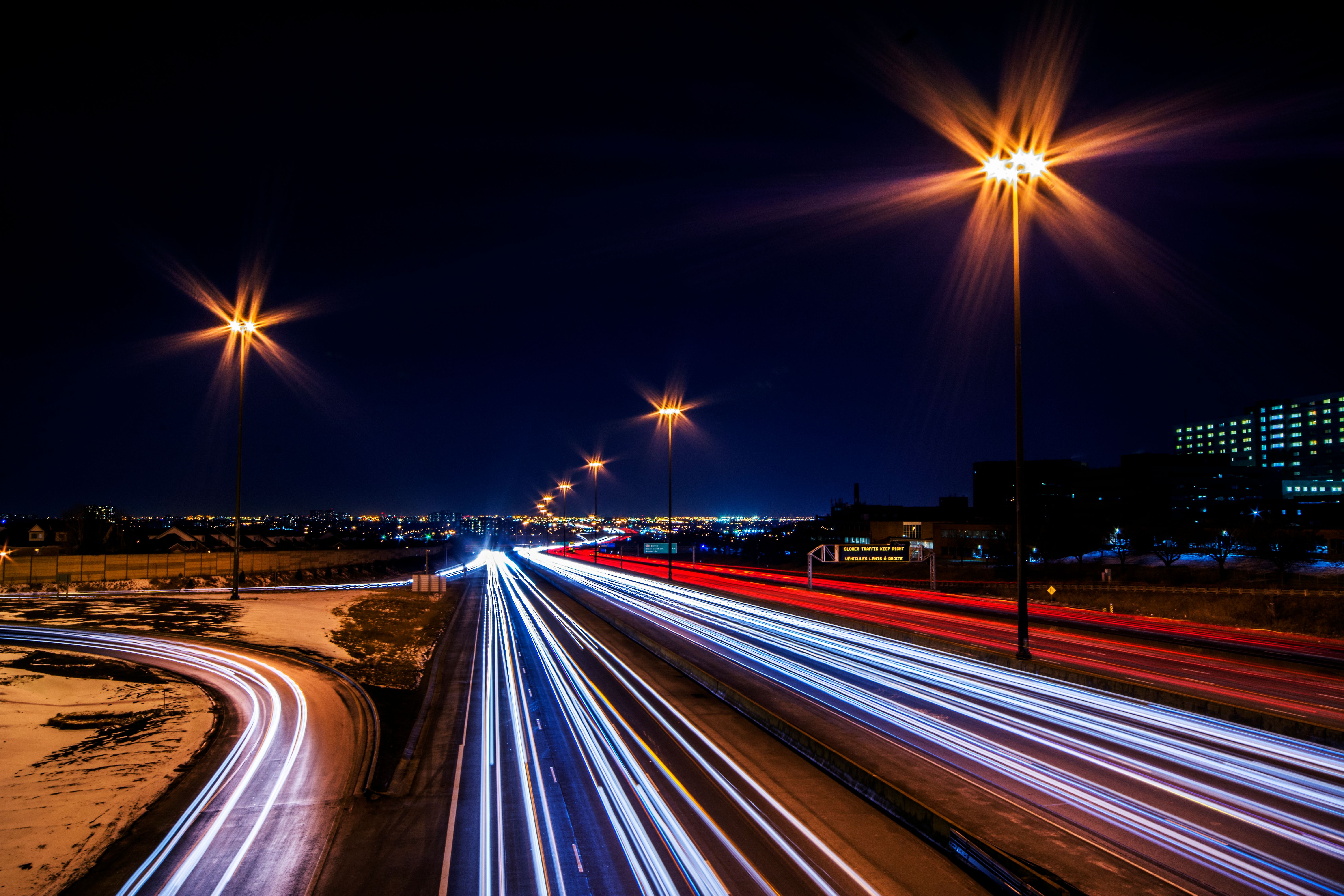Captivating long exposure shot of highway light trails at night, showcasing dynamic movement and vib