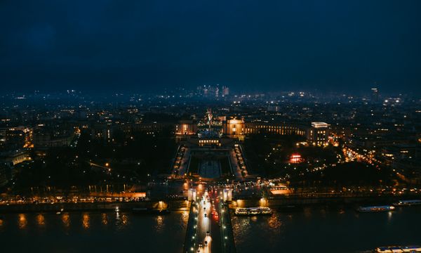 Stunning nighttime aerial cityscape of Paris highlighting iconic landmarks.