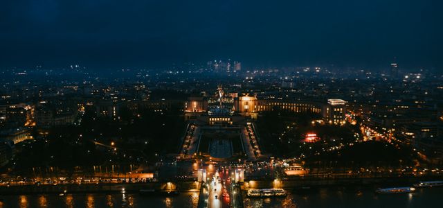 Stunning nighttime aerial cityscape of Paris highlighting iconic landmarks.
