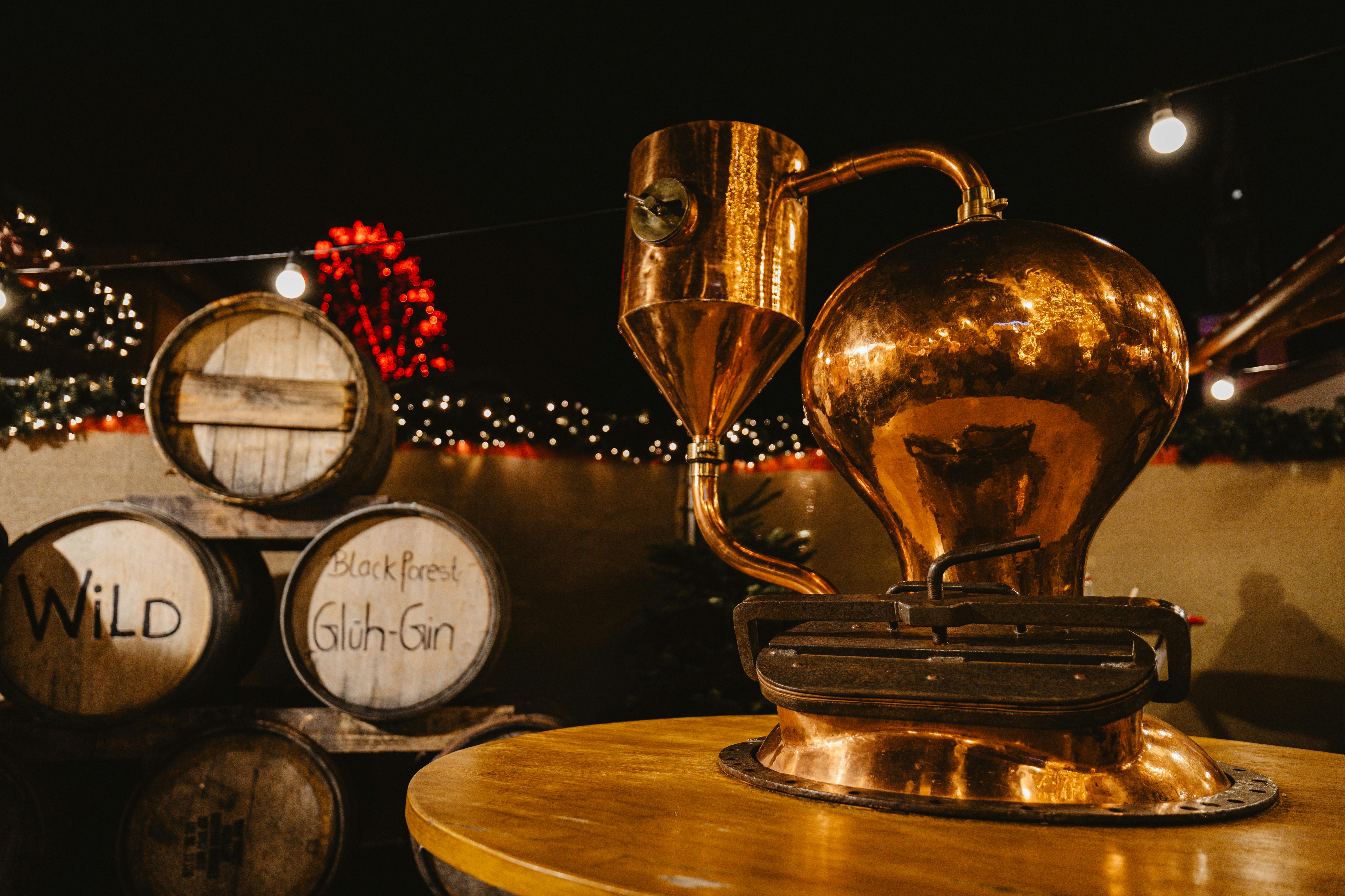 vintage copper still and barrels at night market