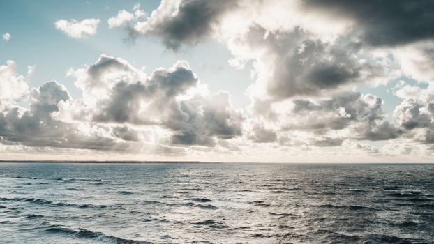 Captivating view of a moody sky with clouds above a vast ocean, capturing nature's raw beauty.