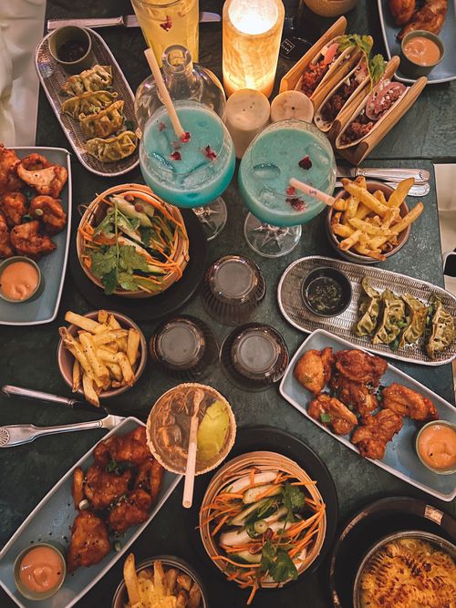 Free Aerial view of a colorful dinner table with various foods and drinks. Stock Photo