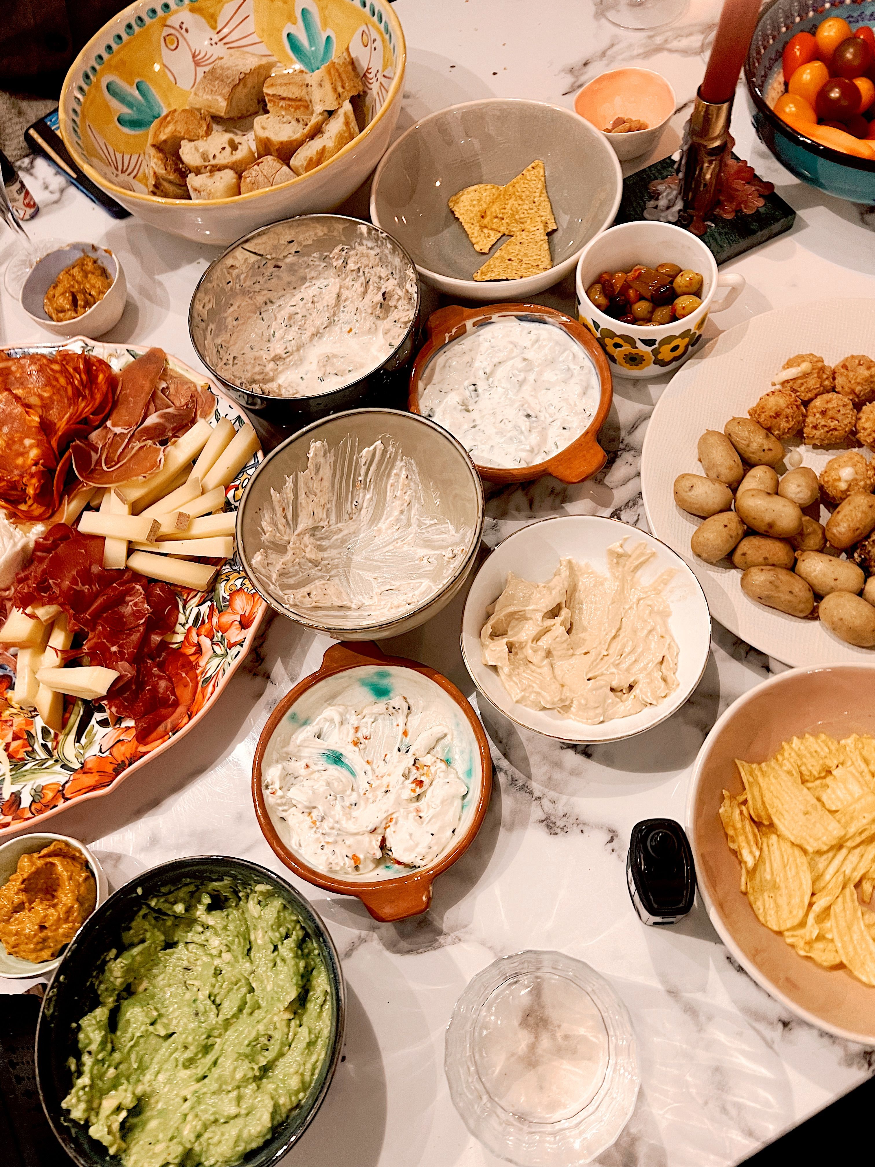 A diverse spread of snacks, cheeses, and delicious dips perfect for gatherings.